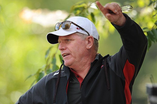 Arkansas coach Chris Bucknam speaks to an assistant coach Saturday, Oct. 1, 2016, during the 28th annual Chile Pepper Cross Country Festival at Agri Park in Fayetteville.