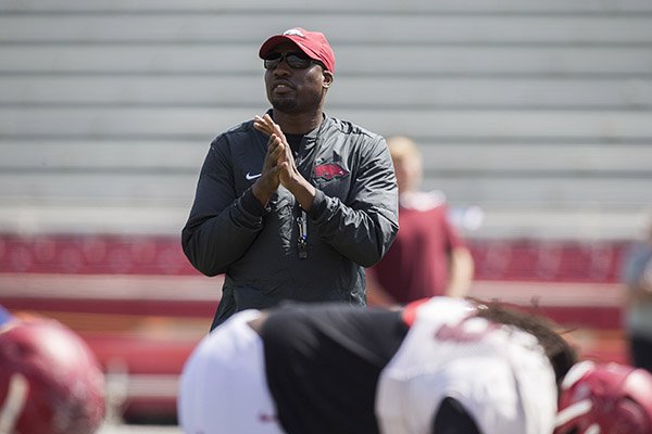 Arkansas assistant coach John Scott watches warmups prior to practice Saturday, April 15, 2017, in Fayetteville. 