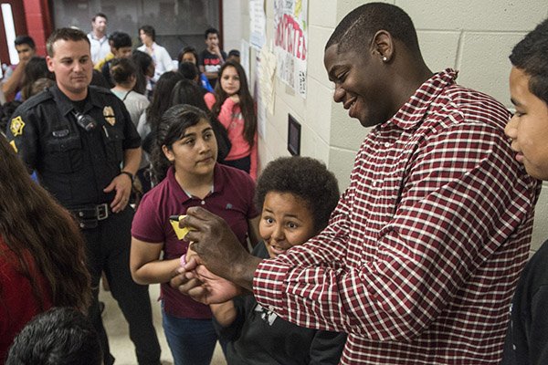 Ronnie Brewer takes photos with students at Sonora Middle School on Friday, May 15, 2015, in Springdale. 