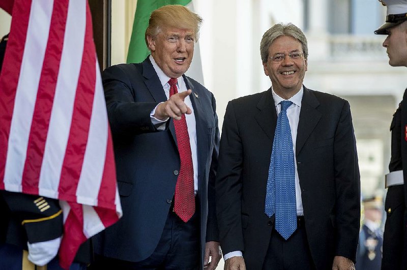 President Donald Trump greets Italian Prime Minister Paolo Gentiloni as he arrives Thursday at the West Wing of the White House.