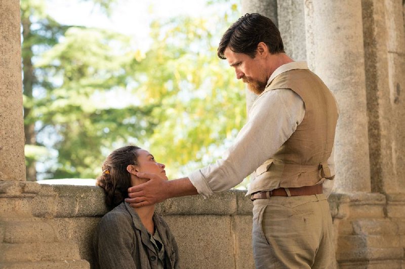 Artist Ana (Charlotte Le Bon) and Associated Press reporter Chris (Christian Bale) form two sides of a love triangle in Terry George’s historical drama The Promise. 
