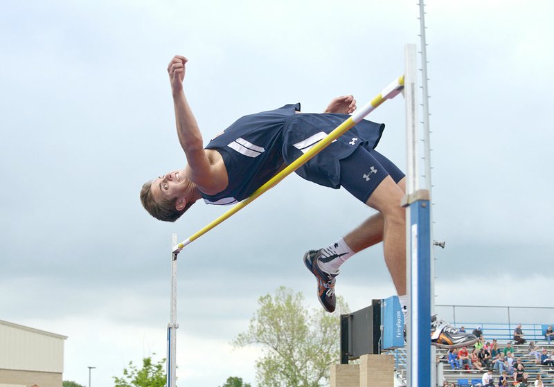 Seth Stanley of Rogers Heritage attempts to high jump the bar at 6 feet, 2 inches Thursday during the McDonald Relays at Fort Smith Southside.