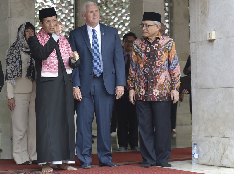 U.S. Vice President Mike Pence, center, is given a tour by the Grand Imam of Istiqlal Mosque Nasaruddin Umar, left, and the Chairman of the mosque Muhammad Muzammil Basyuni, right, during his visit to the largest mosque in Southeast Asia, in Jakarta, Indonesia, Thursday, April 20, 2017. 