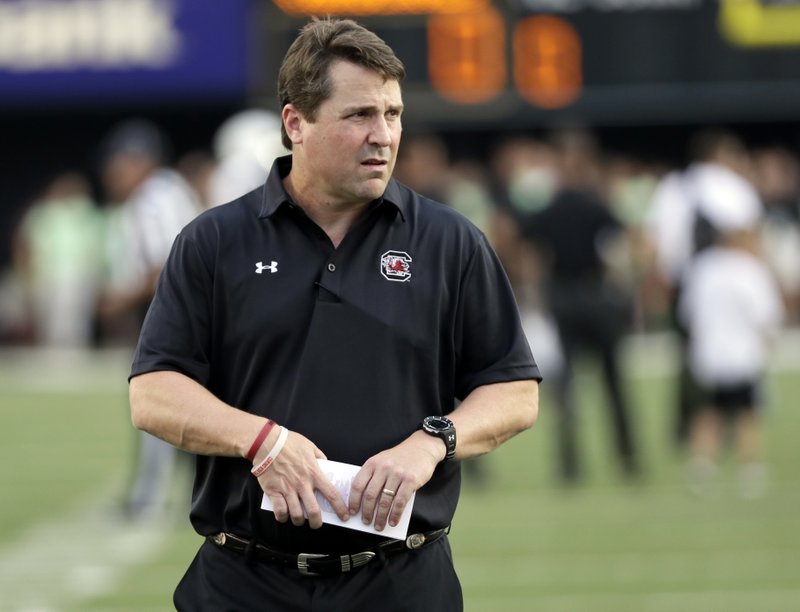 In this Sept. 1, 2016, file photo, South Carolina coach Will Muschamp watches players warm up for an NCAA college football game against Vanderbilt in Nashville, Tenn.