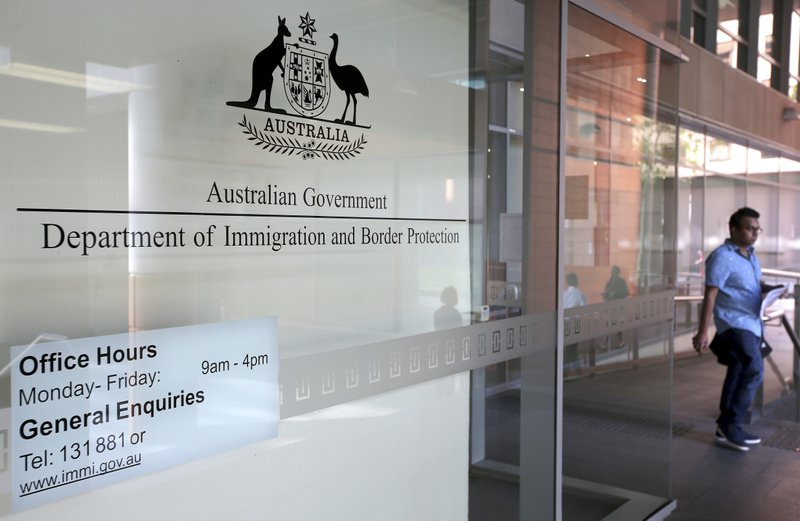 A man leaves the Department of Immigration and Border Protection offices in Sydney, Thursday, April 20, 2017. Australia plans to tighten its citizenship rules to require higher English language skills, longer residency and evidence of integration such as a job. 