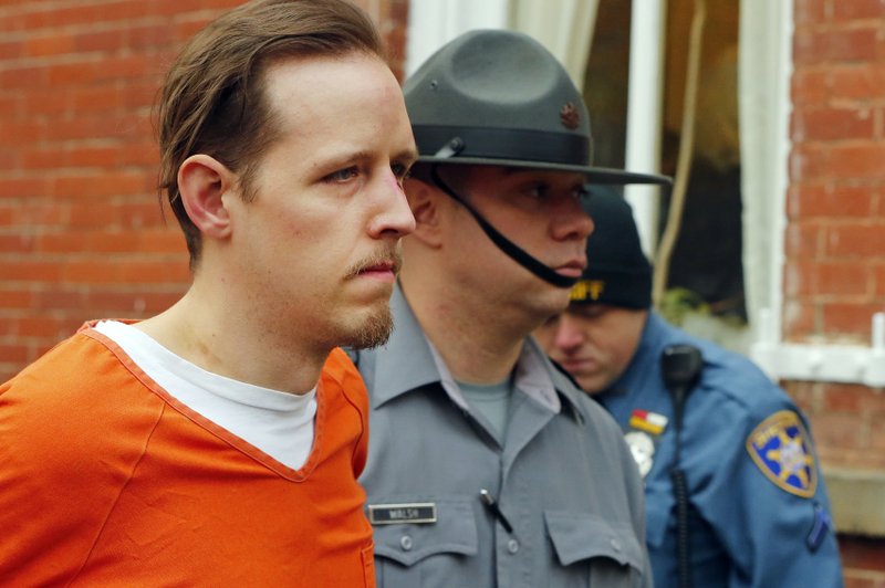 Eric Frein is escorted by police out of the Pike County Courthouse on Oct. 31, 2014, after his arraignment in Milford, Pa.
