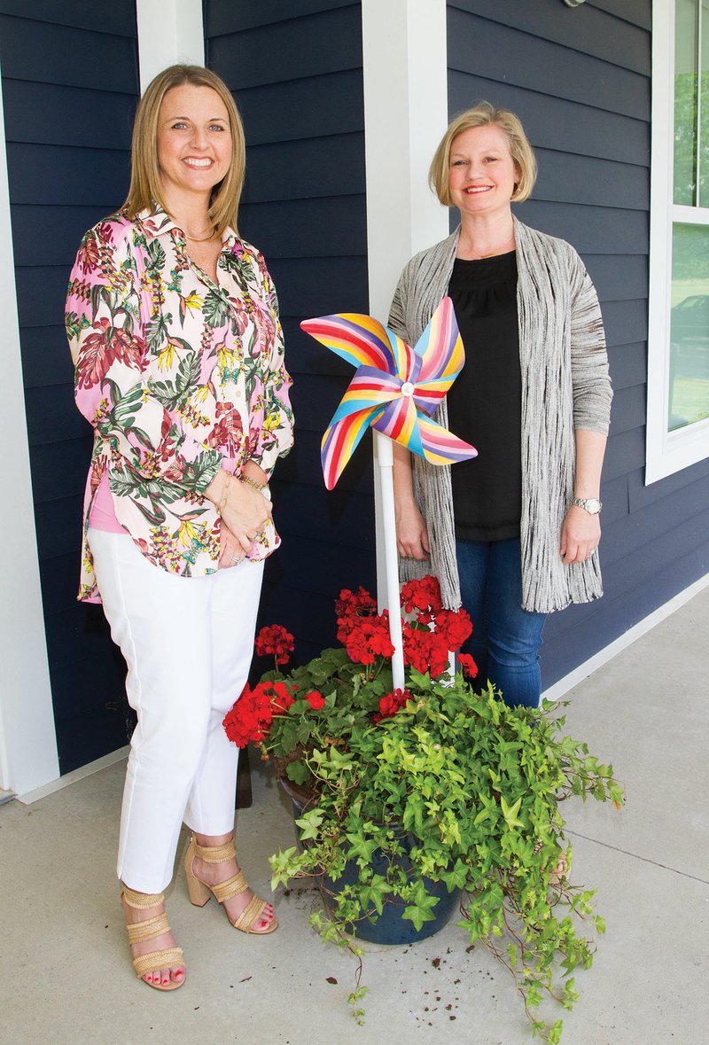 Robin Connell, left, executive director of the Child Safety Center of White County, and Allison Camferdam, center board member, stand with a metal pinwheel, which is similar to the ones that will be auctioned off at the second Pinwheels for Provisions fundraiser May 5 in Searcy. The event raised almost $15,000 a year ago for the Child Safety Center, a child advocacy center in Searcy