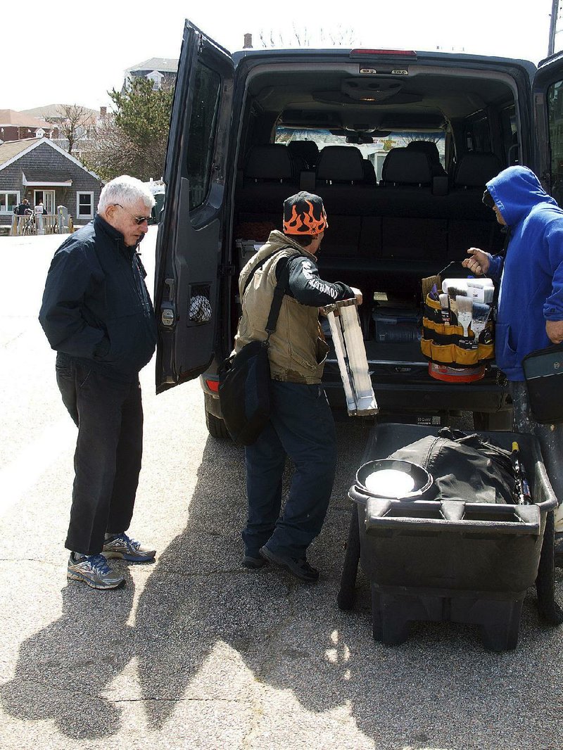 Riders load tools into Vin McAloon’s taxi in New Shoreham, R.I., earlier this month. McAloon, Block Island’s retired police chief, drives one of two taxis that operate year-round on the island.