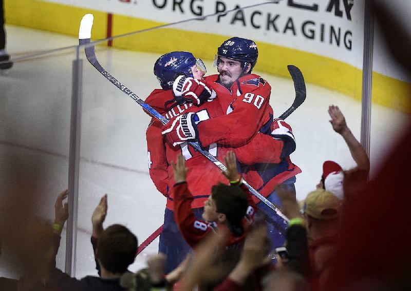 Washington Capitals right wing Justin Williams (left) is hugged by teammate Marcus Johansson after scoring the winning goal in overtime as the Capitals defeated the Toronto Maple Leafs 2-1. The Captials lead the series 3 games to 2.