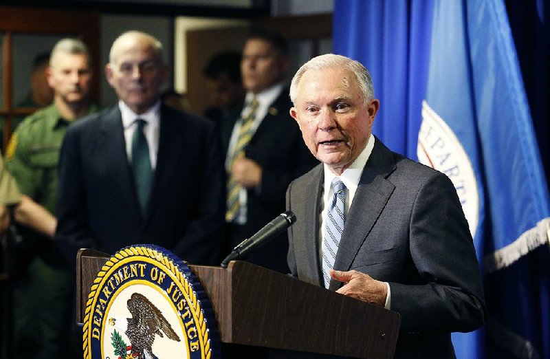 Attorney General Jeff Sessions speaks to reporters Thursday after he and Homeland Security Secretary John Kelly (left) toured ports of entry in El Paso, Texas. On Friday, Sessions sent letters threatening to cut funding to nine jurisdictions that reportedly do not cooperate with federal authorities regarding illegal aliens.