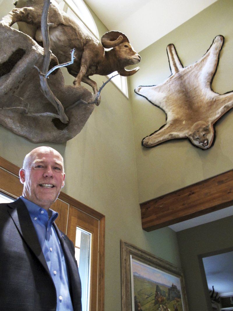 FILE - In this Oct. 5, 2016 file photo, gubernatorial candidate, Republican Greg Gianforte poses below animal trophies in his home in Bozeman, Mont.