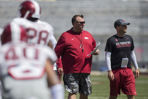 Coach Bret Bielema and assistant Barry Lunney Jr. look on during Arkansas football practice on Saturday, April 15, 2017, at Donald W. Reynolds Razorback Stadium in Fayetteville.
