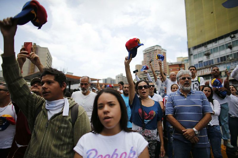 Silent marchers fill the streets Saturday in Caracas, Venezuela, to honor the people killed in recent unrest. 