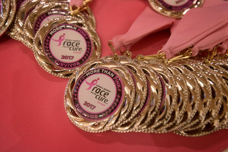 Survivor medals sit on a table during the survivor reunion breakfast Saturday during the annual Susan G. Komen Ozark Race for the Cure at Pinnacle Hills Promenade in Rogers. For photo gallery, go to www.nwadg.com/photos.