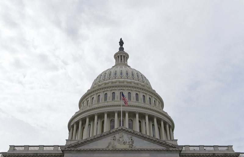 In this photo taken Feb. 28, 2017, a flag flies on Capitol Hill in Washington. Lawmakers return to Washington this week to a familiar quagmire on health care legislation and a budget deadline dramatized by the prospect of a protracted battle between President Donald Trump and congressional Democrats over his border wall. 