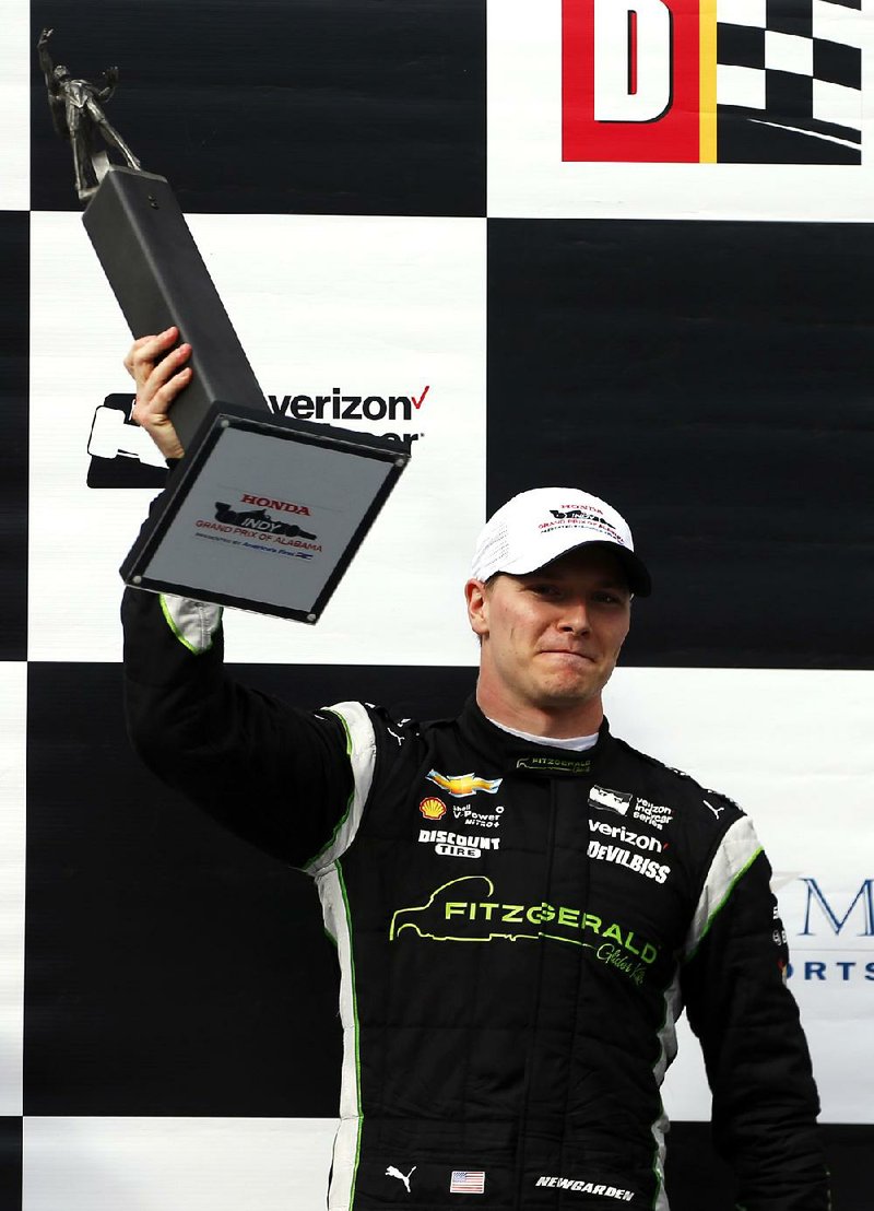 Josef Newgarden celebrates after winning the Indy Grand Prix of Alabama auto race, Sunday, April 23, 2017, in Birmingham, Ala. 