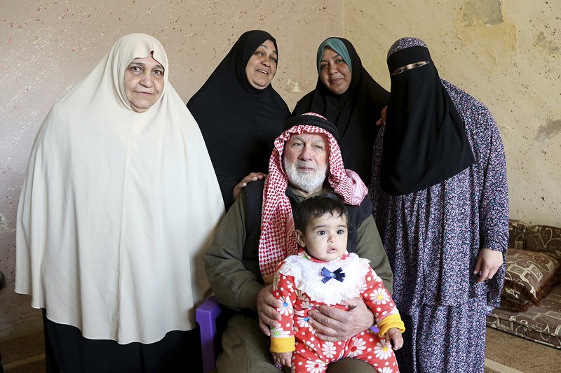 In this photo taken Wednesday, Feb. 18, 2017, five generations of a Palestinian refugee family, the Abu Massouds, pose for a portrait.  
