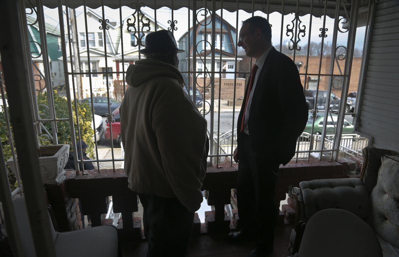 In this Feb. 1, 2017, photo, Raymond Murray gets a visit from his lawyer, Robert Seewald, right, at his home in New York. Murray is the victim of deed theft, a foreclosure fraud where older people are mostly the target. 