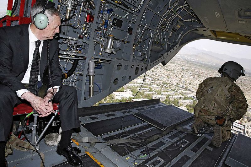 Defense Secretary James Mattis looks out over Kabul, Afghanistan, as he arrives Monday for meetings about the Afghan war and the United States’ role.