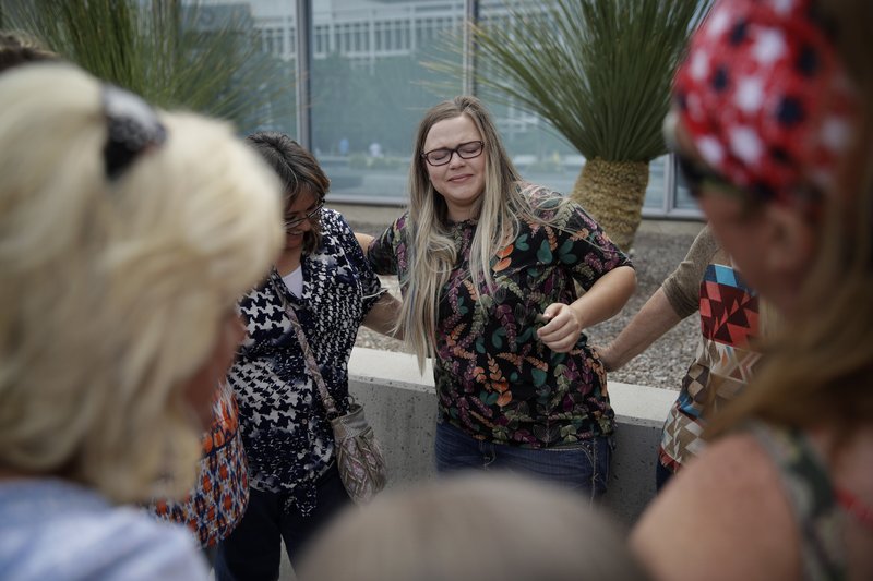 Bailey Logue, center, daughter of Cliven Bundy, embraces others after a partial verdict outside of the federal courthouse, Monday, April 24, 2017, in Las Vegas. 