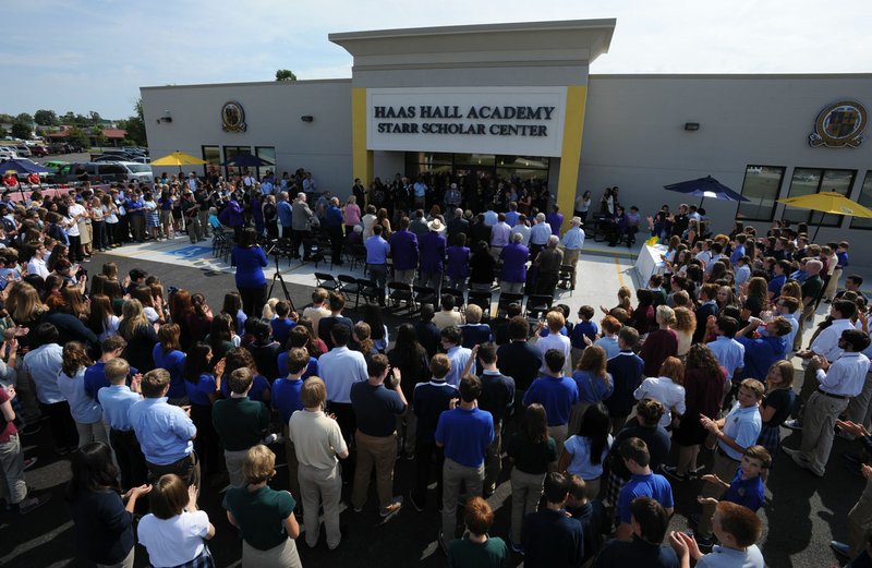 NWA Democrat-Gazette/ANDY SHUPE Students, faculty and community members applaud Sept. 22, 2015, as Martin Schoppmeyer Jr., superintendent and founder of Haas Hall Academy, speaks during a dedication ceremony for the school&#8217;s Starr Scholar Center in Fayetteville. The renovated facility is located at 380 N. Front Street and is named in honor of Billie Jo Starr and her family.
