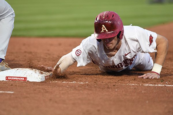 Arkansas' Carson Shaddy slides into first base during a game against LSU on Friday, April 7, 2017, in Fayetteville. 
