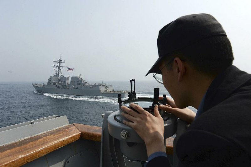 A South Korean navy sailor watches the destroyer USS Wayne E. Meyer on Tuesday during joint exercises with the United States in the Yellow Sea west of South Korea.