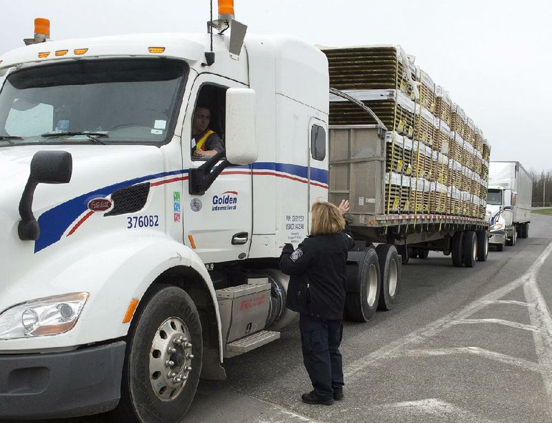 A truck carrying wood goes through the customs checkpoint Tuesday as it enters Champlain, N.Y. Canadian leaders expressed concern that tariffs on softwood lumber, imposed by President Donald Trump’s administration, will hurt people on both sides of the border. 