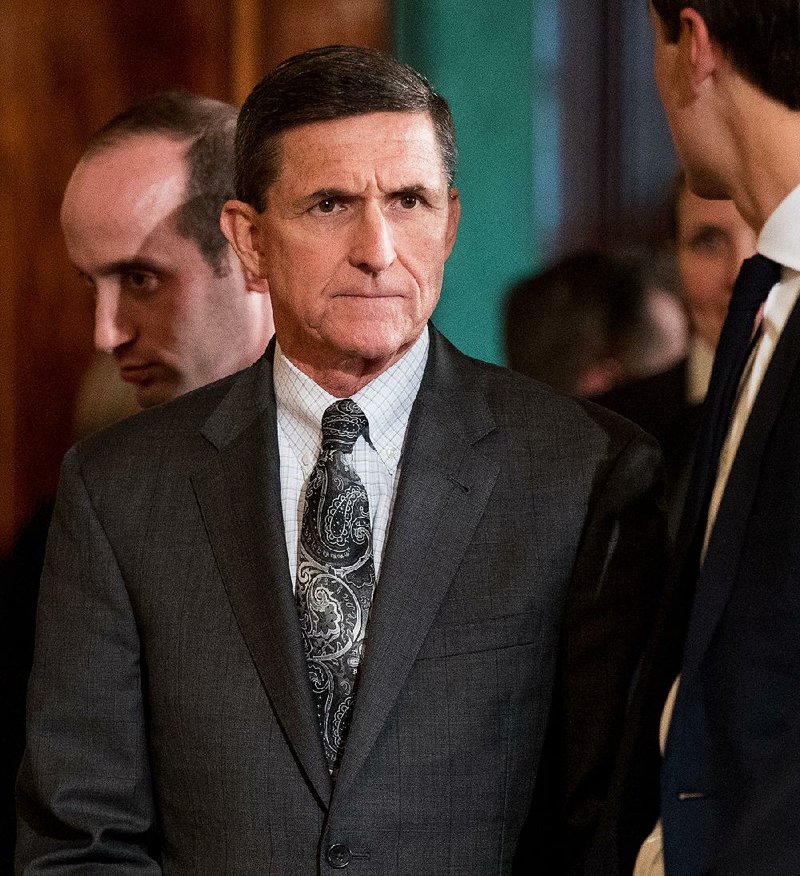 Then National Security Adviser Michael Flynn, center, arrives in the East Room of the White House in Washington, Monday, Feb. 13, 2017. 