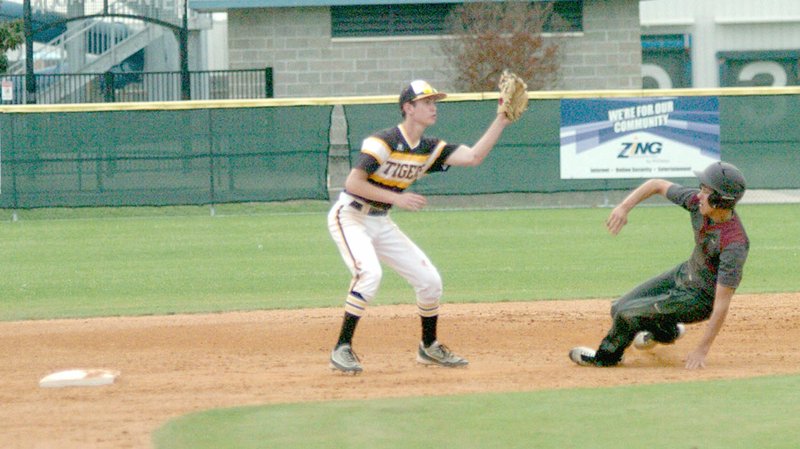 MARK HUMPHREY ENTERPRISE-LEADER/Prairie Grove second baseman Silas Myane receives a throw as Gentry&#8217;s Carlos Alvarez Del Castillo slides towards the base. The Tigers beat Gentry, 10-2, on April 13.