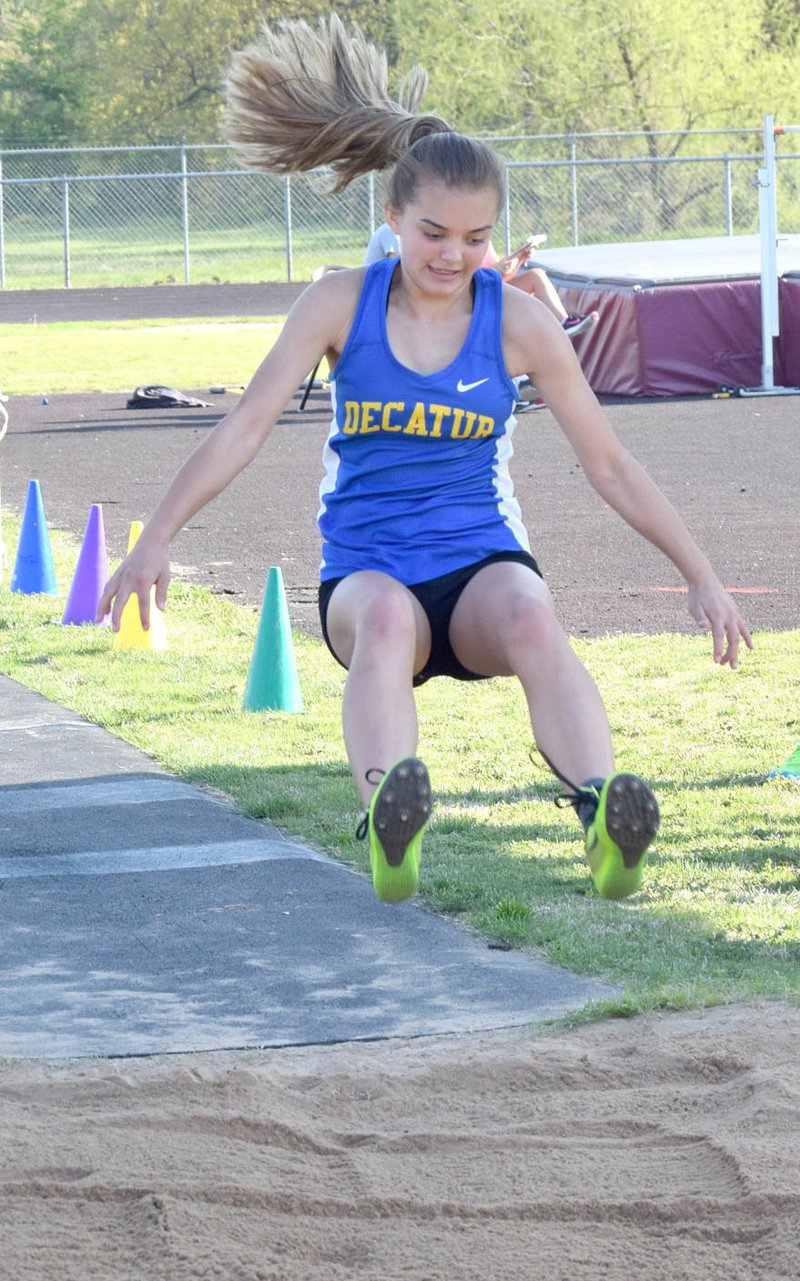 Photo by Mike Eckels Decatur&#8217;s Destiny Meija gets ready to stick her landing in the triple jump during the April 11 Gentry JH Relays in Gentry. Meija took three first place finishes in the 1A Junior High District track meet in Harrison April 19 to help the Decatur girls take its second junior high district championship in a row.