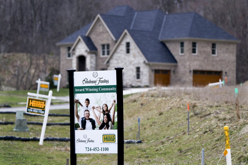 In this Monday, Feb. 27, 2017, photo, real estate signs mark the lots near one of the new homes for sale in a development for new homes in Cranberry Township, Butler County, Pa. 