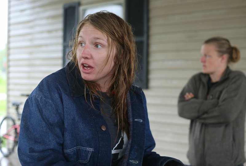 NWA Democrat-Gazette/DAVID GOTTSCHALK Jessica Hopkins sits Wednesday at the 7 Hills Homeless Center as she recounts the flash flood event that caused her to escape from the high water of Town Branch Creek earlier in the morning in south Fayetteville. Heavy rain caused flooding and submerged campsites and portions of the Razorback Greenway, including portions of the Town Branch section.