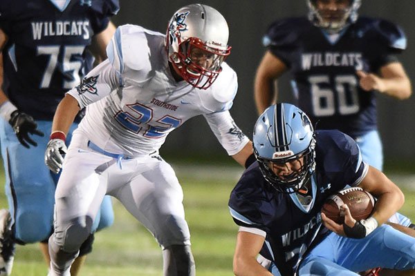 Fort Smith Southside linebacker Darrin Davenport (22) helps make a tackle during a game against Springdale Har-Ber on Friday, Sept. 2, 2016, in Springdale. 