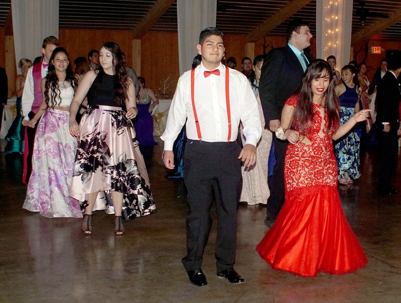 Gentry students took to the dance floor during the opening line dance held at Gentry High School’s prom on Saturday night. Bryan Gonzalez and Dalilah Sanchez (in red) are in the foreground.