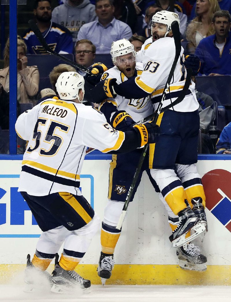 Nashville’s Vernon Fiddler (right) Mattias Ekholm (center) and Cody McLeod great each other after Fiddler scored what turned out to be the game-winning goal in the Predators’ 4-3 victory over St. Louis on Wednesday in the NHL Western Conference semifinals.