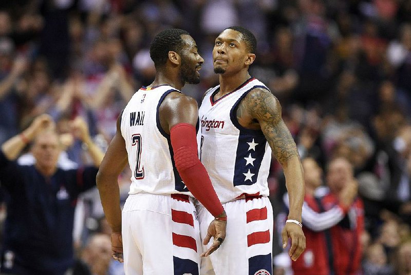 Washington guards John Wall (left) and guard Bradley Beal combined for 47 points, 11 rebounds and 15 assists to push the Wizards past Atlanta 103-99 in Game 5 of their NBA Eastern Conference first-round playoff series Wednesday.