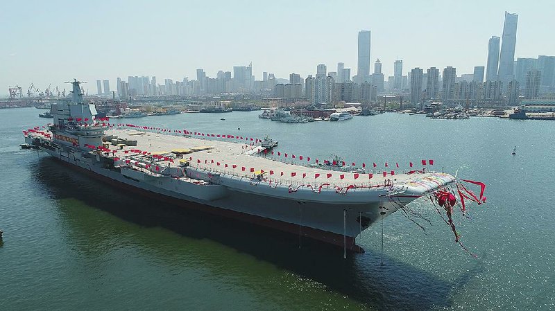 China’s new aircraft carrier is transferred from dry dock at a launch ceremony Wednesday at a shipyard in Dalian in northeastern China’s Liaoning province.