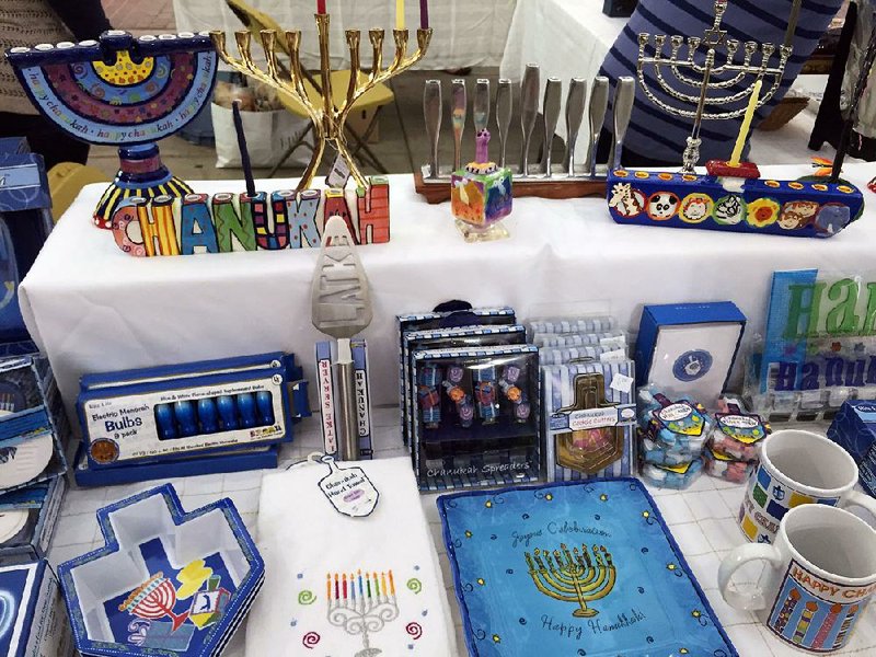 Tables of Jewish and Israeli gifts and decorations help make festive the concourse at War Memorial Stadium during the Jewish Food & Cultural Festival. 