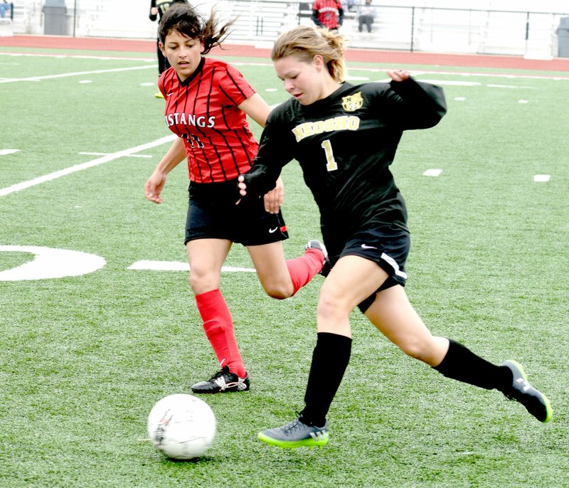 Photo by Rick Peck McDonald County freshman defender Aaliyah Rubio races down a Neosho Wildcat during Neosho&#8217;s 6-0 win on April 22 at Joplin High School.