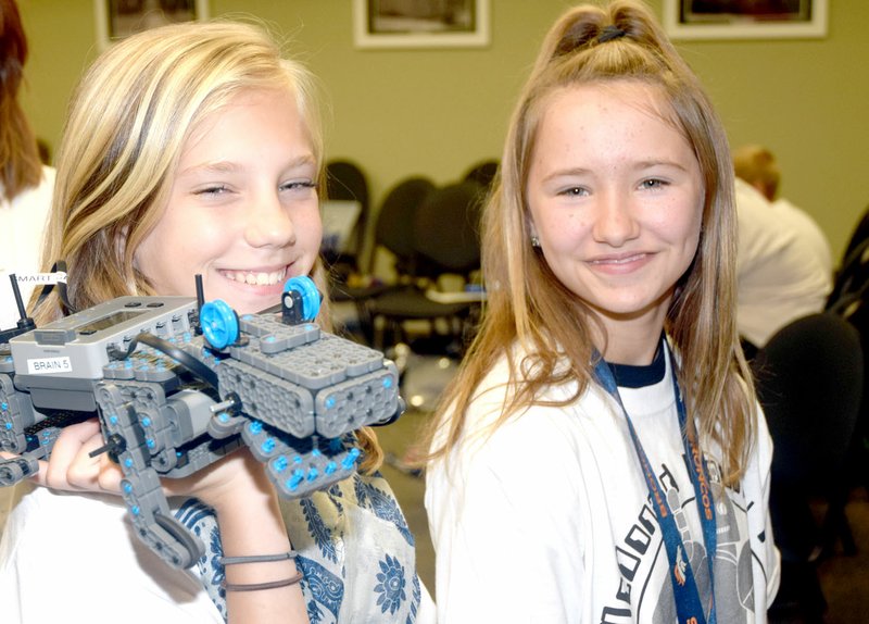 Photo by Rick Peck Micah Sebastian, left, and Skylor Taylor, sixth-graders at White Rock, take their robot, &#8220;Allie the Alligator,&#8221; to the next station at the McDonald County School District&#8217;s first annual Robotfest.