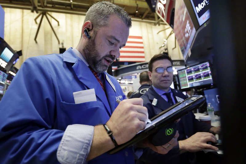 Trader Kevin Lodewick, left, works on the floor of the New York Stock Exchange, Wednesday, April 26, 2017. Stock markets around the world made only modest moves on Wednesday, waiting to see what the White House has in store for U.S. tax policy. (AP Photo/Richard Drew)