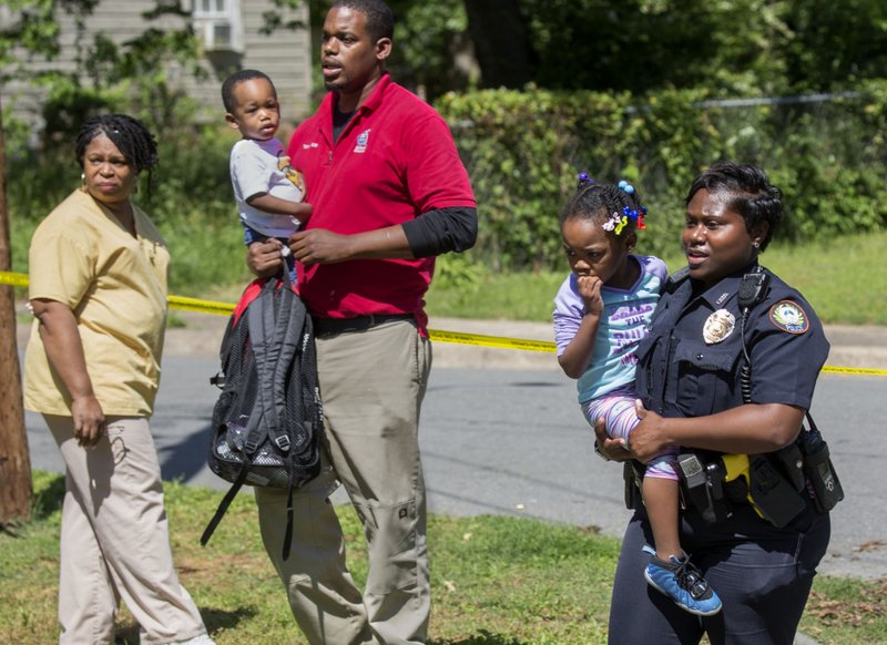 Arkansas Democrat-Gazette/BENJAMIN KRAIN --4/27/17--
A child is taken to her mother as she is moved from an in-home day care in the 1800 block of Park Lane in Little Rock, where the homeowner was killed in a drive-by shooting Thursday. No children were hurt.