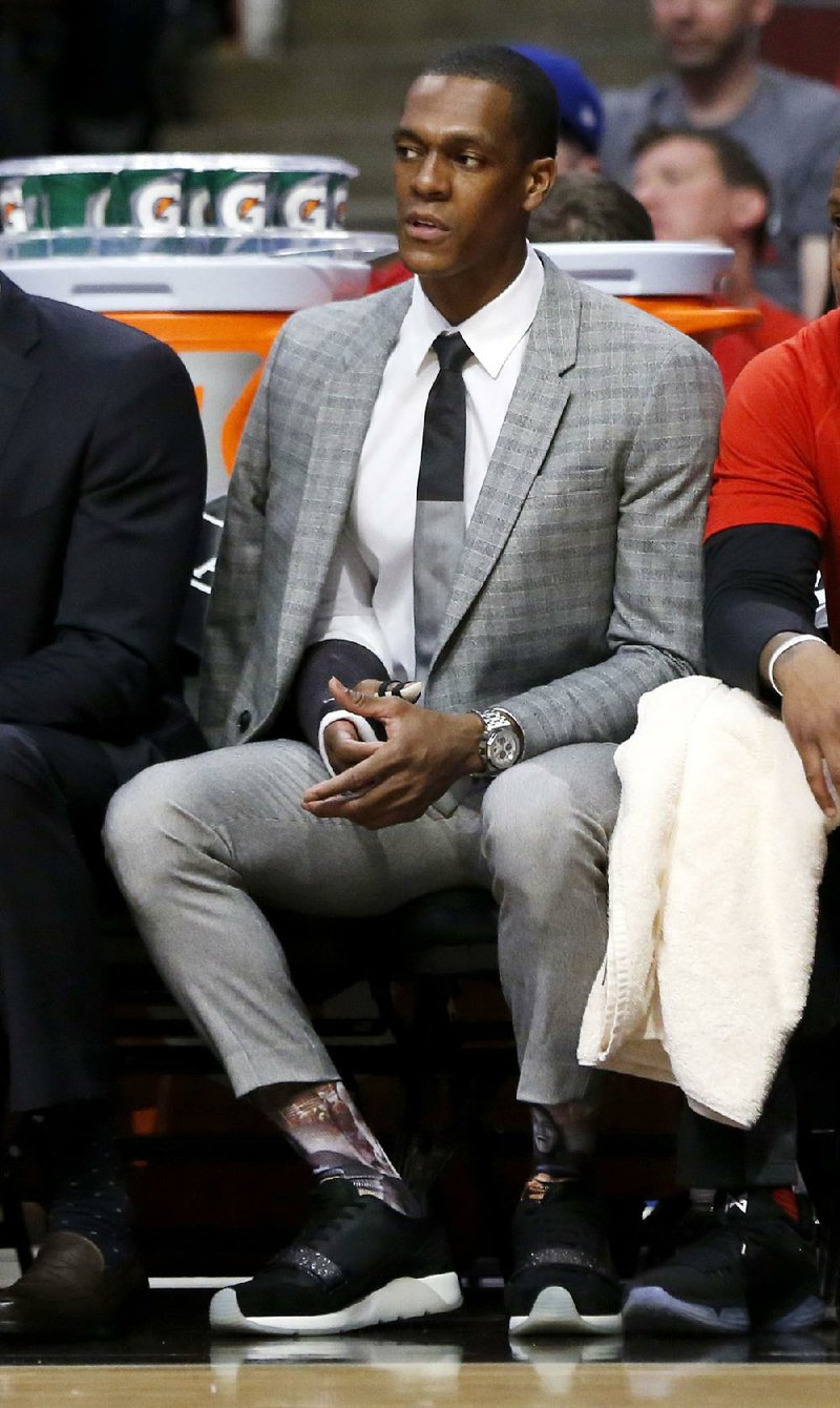 Injured Chicago Bulls' Rajon Rondo watches his team from the bench during the first half in Game 4 of an NBA basketball first-round playoff series against the Boston Celtics in Chicago, Sunday, April 23, 2017. 
