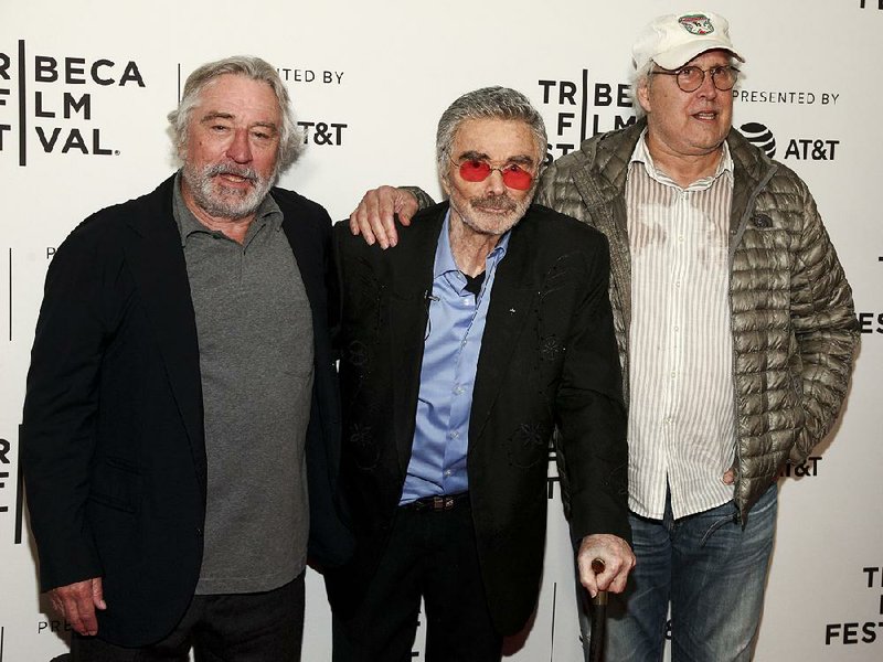 Robert De Niro (from left), Burt Reynolds and Chevy Chase seem like long-lost friends at the premiere of Reynolds’ latest film Dog Years, which also stars Glenwood native Clark Duke.