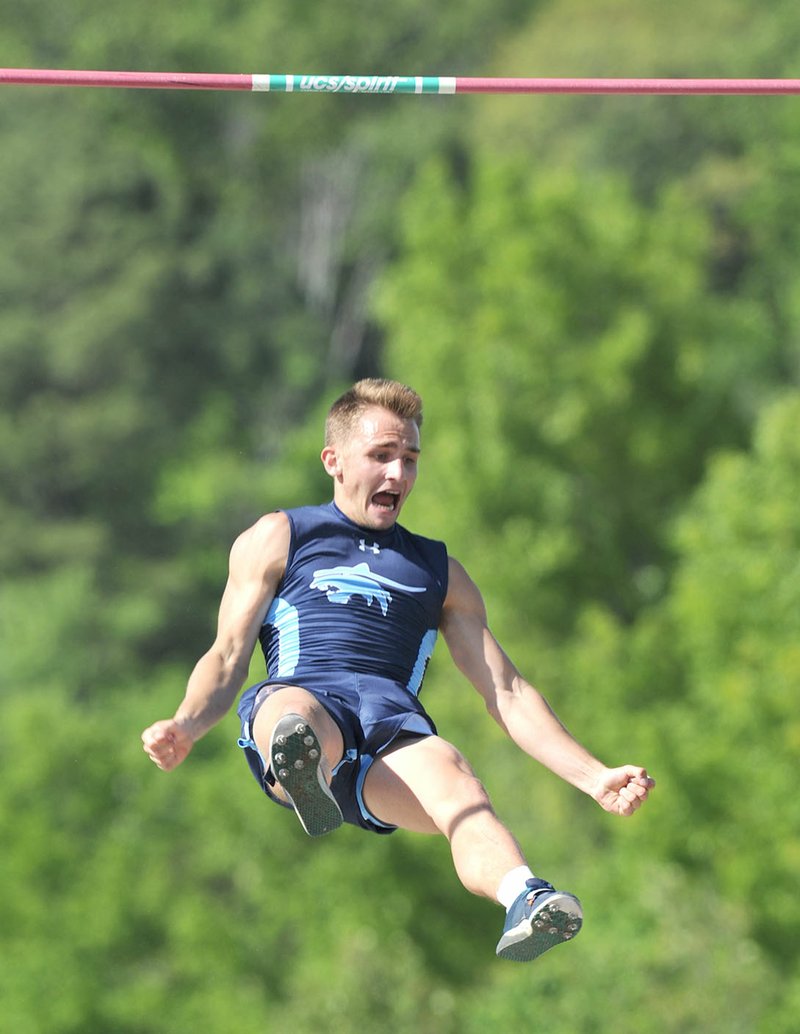 Zach McWhorter of Springdale Har-Ber celebrates Thursday after clearing 17 feet in the pole vault during the Class 7A West Outdoor Track and Field Meet at the Fayetteville track and field complex.