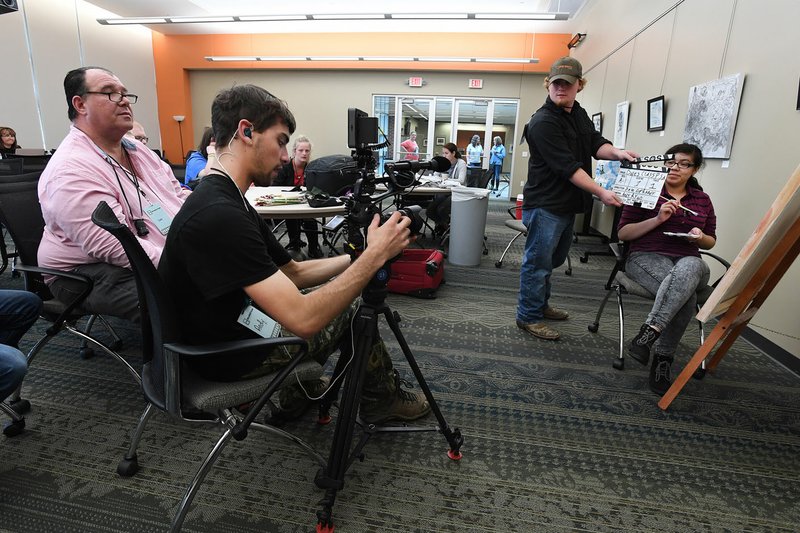 Emily Alfaro (right), a Rogers High School student, and Bailey Warner (second from right), South Side High School student in Bee Branch, work Thursday with instructor Dale Oprandy (left) and cinematographer Andy Ryan during a film camp at Northwest Arkansas Community College in Bentonville. Arkansas Rehabilitation Services and Arkansas Transition Services collaborated with veteran filmmaker Joey Travolta by hosting his Inclusion Film Camp.