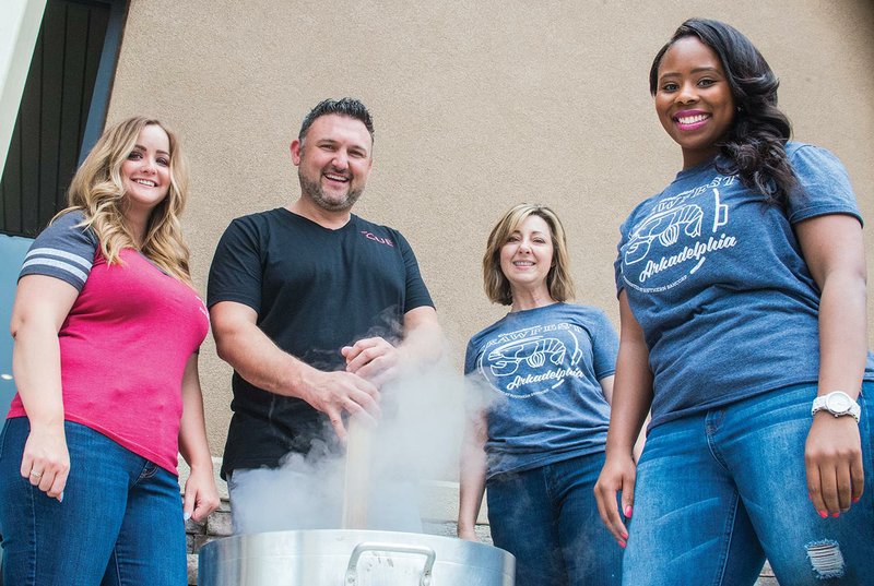 Co-owners of The Cue Eatery and Pool Hall, KaCee Reed, from left, and Aaron Reed, cook up some crawfish with Shelley Loe and Tiffany McNeal with the Arkadelphia Chamber of Commerce as they get ready for Arkadelphia’s Downtown Crawfest set for Friday and Saturday.