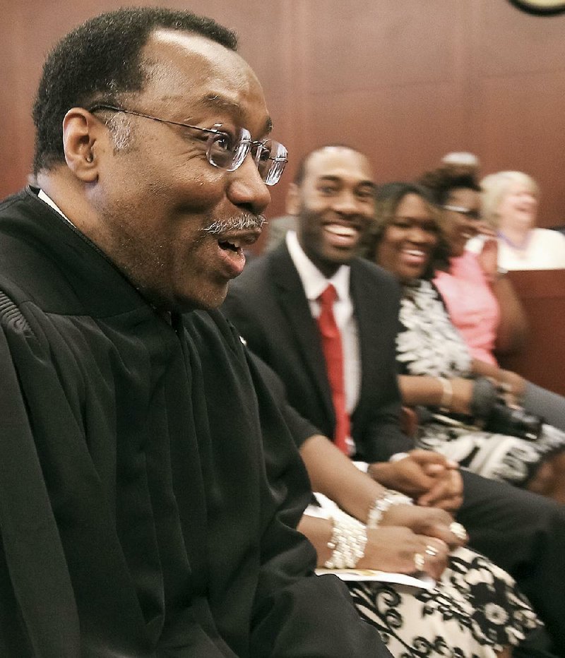 Lavenski Smith, chief judge of the 8th U.S. Circuit Court of Appeals, sits with family members during a ceremony honoring him Friday in Little Rock.