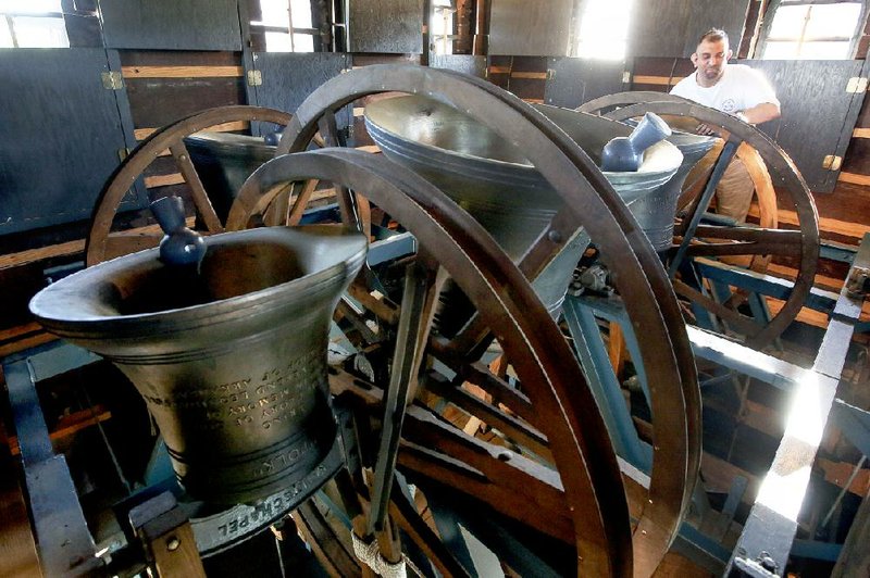 William Hronas of Little Rock does a check of the bells in the tower of Trinity Episcopal Cathedral before the church’s Bell Ringing Society begins to get to work Sunday. 